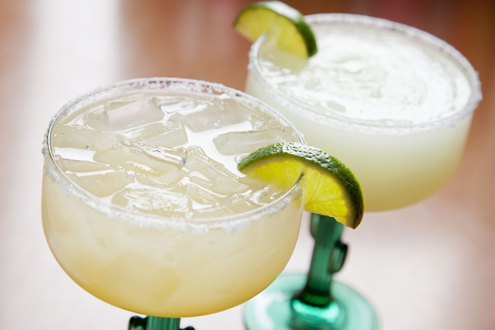 two glasses of classic margarita on the rocks and blended