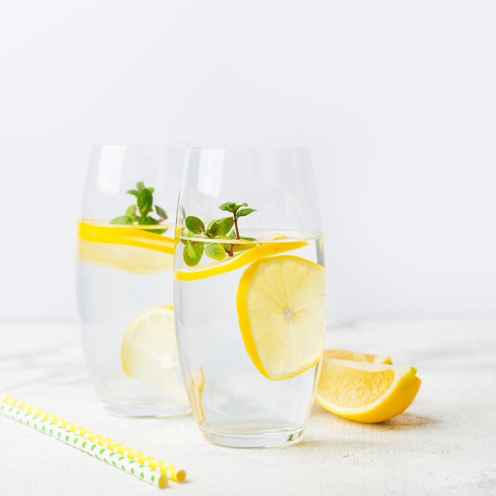two glasses of water with lemon, homemade refreshing lemonade with slices of organic ripe the concept of a healthy lifestyle, the right start to the day, a charge of vivacity