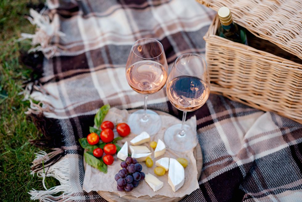 two glasses of wine and summer fruits , summer picnic, idea for outdoor weekend activity