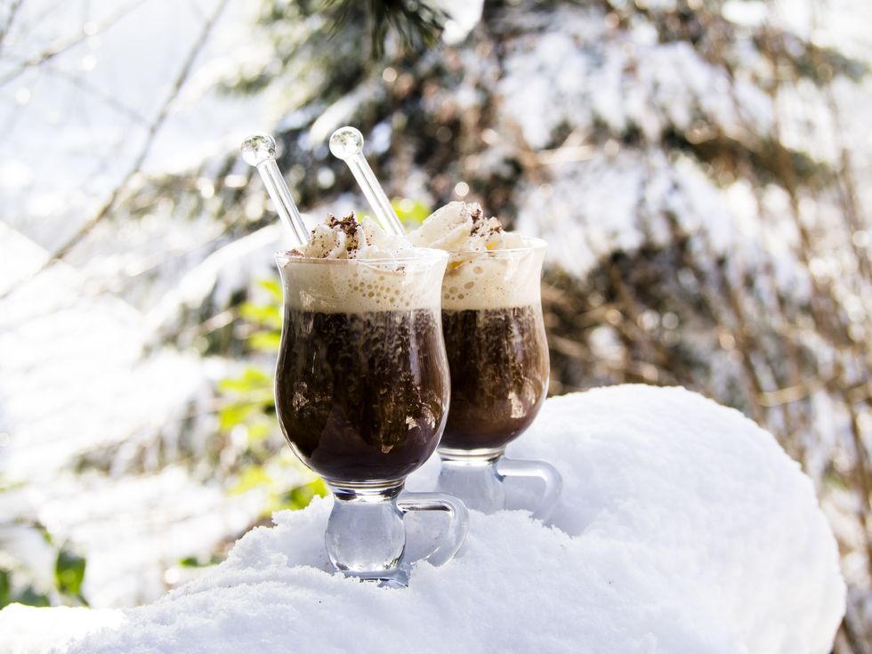 two glasses pharisee with coffee, rum and cream, in snow