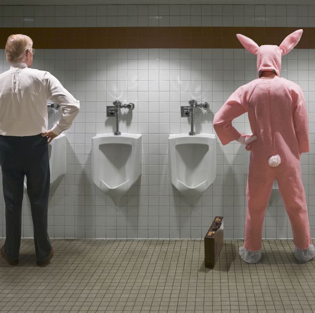 two men standing at urinal, one in rabbit costume, rear view digital composite