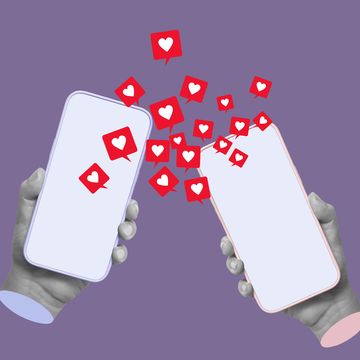 two mobile phones with like symbols from social network in male and female hands on violet color