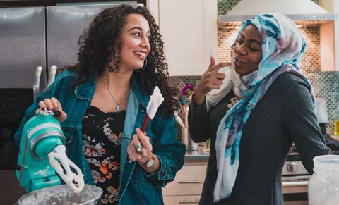 Two Muslim Women Tasting Cake Frosting