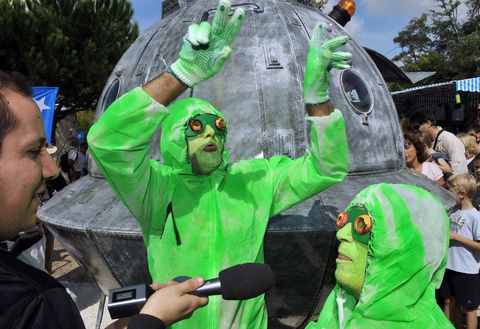 two persons dressed up as aliens answer