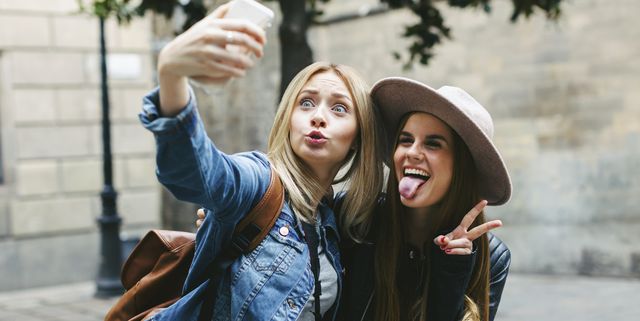 Two playful young women taking a selfie