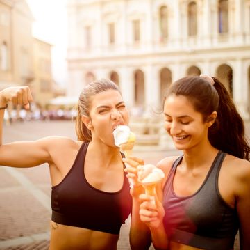 two sporty women eating ice cream.