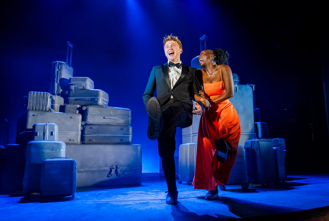 two strangers carry a cake across new york musical