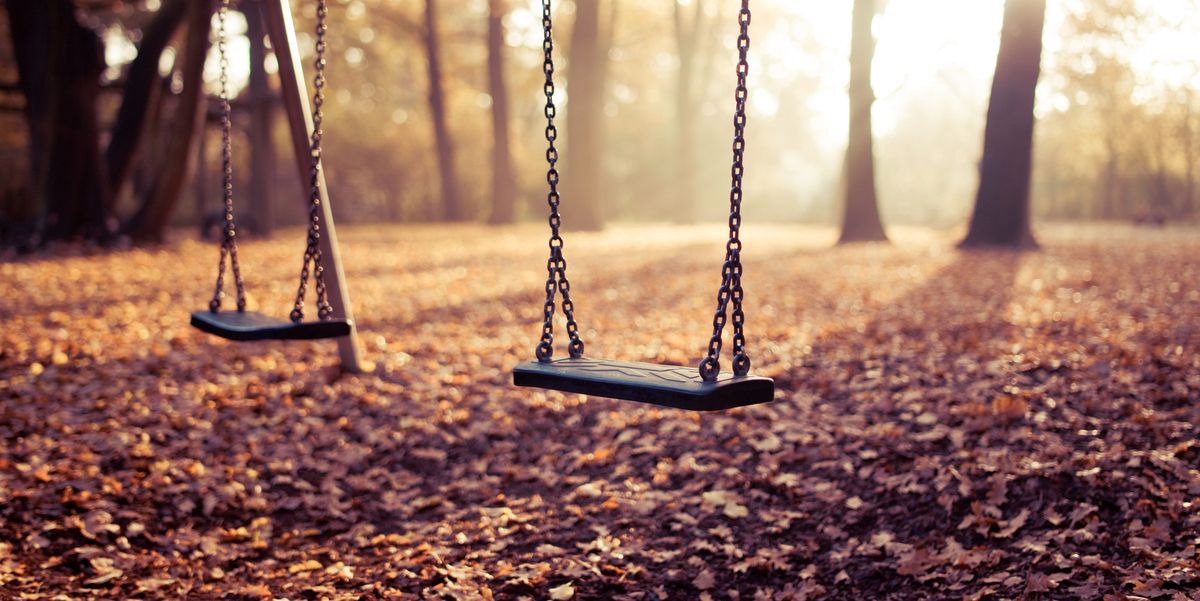 two swings on playground in sunlight