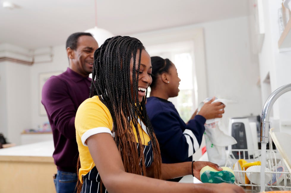 two teenage girls washing dishes