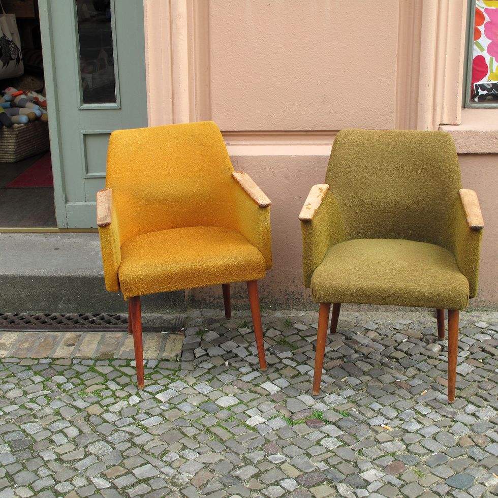 two vintage armchairs in front of a vintage furniture store in berlin, germany