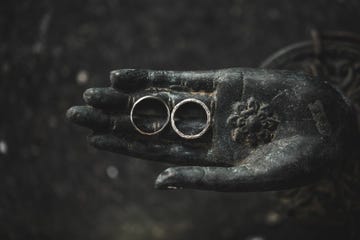 two wedding rings on old vintage spiritual buddha hand