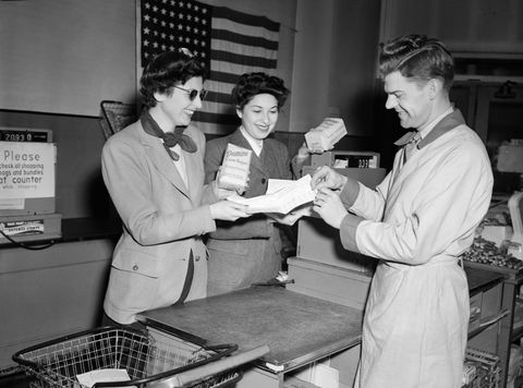 vintage photos of grocery store   women use their war coupons at store during wwii