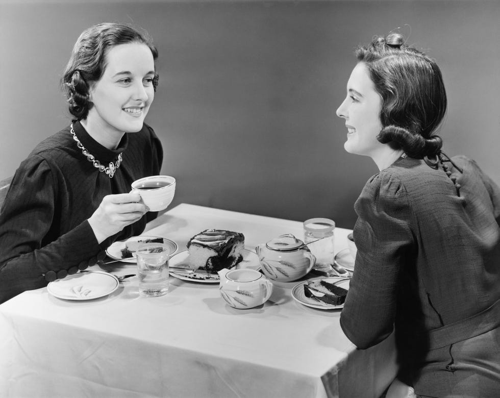 two women having coffee and cake bw