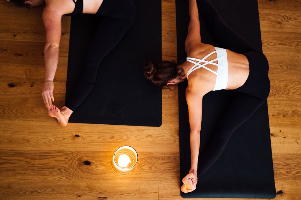 two women practicing yoga together