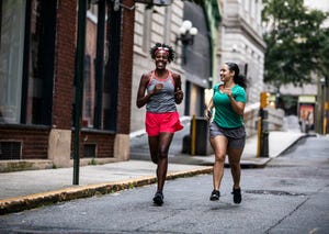 two women running through urban area