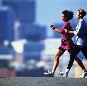 two women speed walking in city, san francisco, california, usa