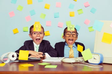 two young businessmen covered with light bulb sticky notes