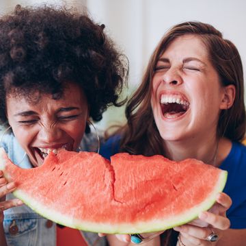 two young girls enjoying a watermelon