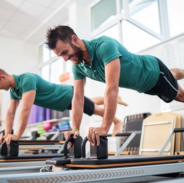 two young men having a pilates class at health club
