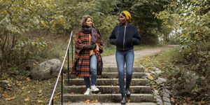 two young women walking in park