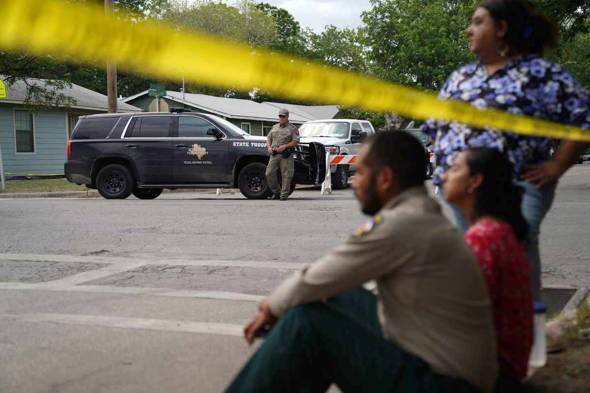 people sit on the curb outside of robb elementary school as state troopers guard the area in uvalde, texas, on may 24, 2022   an 18 year old gunman killed 14 children and a teacher at an elementary school in texas on tuesday, according to the state's governor, in the nation's deadliest school shooting in years photo by allison dinner  afp photo by allison dinnerafp via getty images