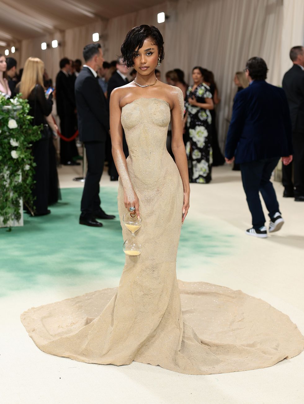 Tyla gets carried up the 2024 Met Gala steps in her Balmain sand dress