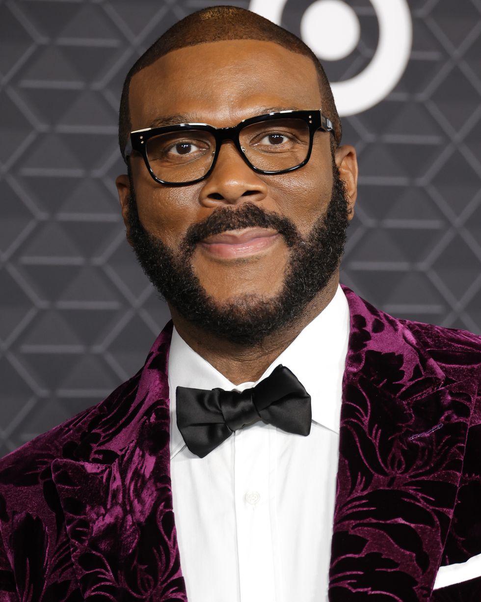 tyler perry smiling for a photo while wearing a bowtie and suit
