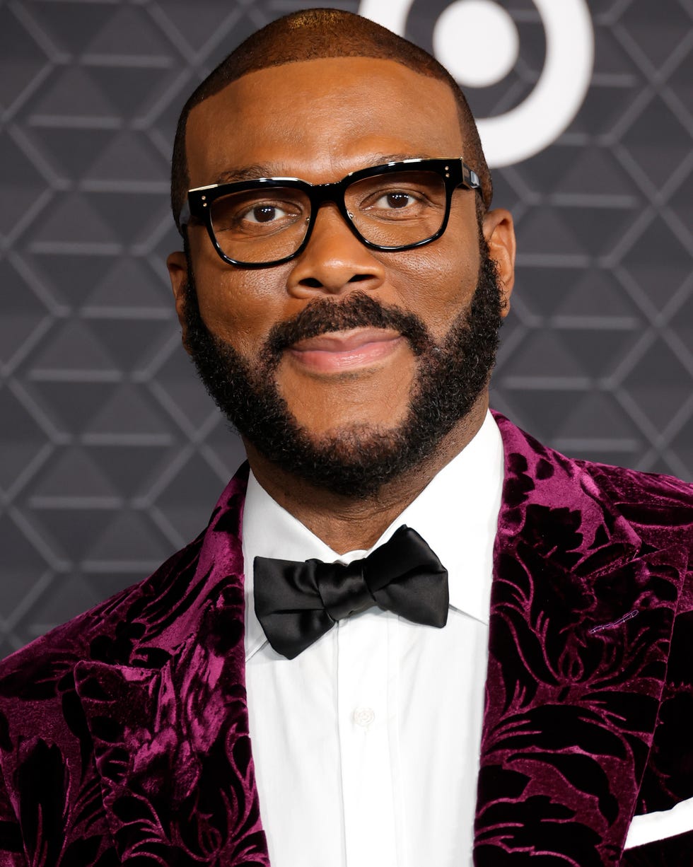 Tyler Perry attends Black Panther: Wakanda Forever premiere tyler perry smiling for a photo while wearing a bowtie and suit