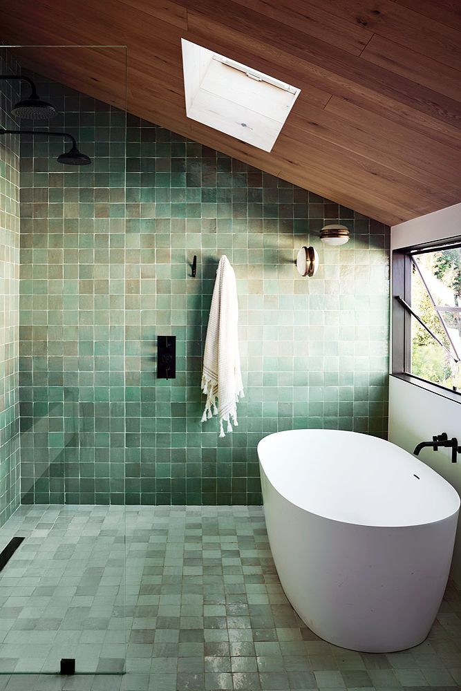 bathroom with green tiles and skylight