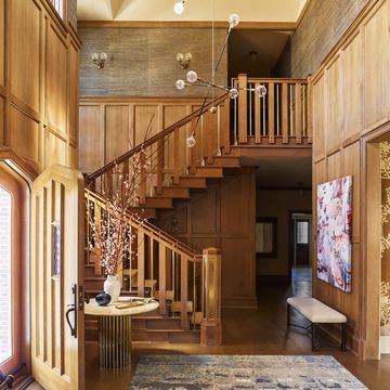 slim brass spindles support the handrail of this oak staircase by designer gideon mendelson and architect ned stoll