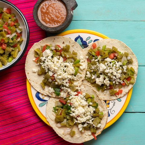 traditional mexican nopal cactus tacos with cheese on turquoise background