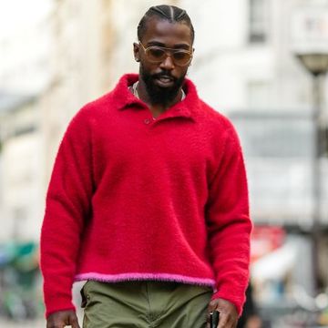 tyrod taylor wearing a red and pink sweater with green pants on the street in paris in a roundup of the best valentine's day gifts for him 2024
