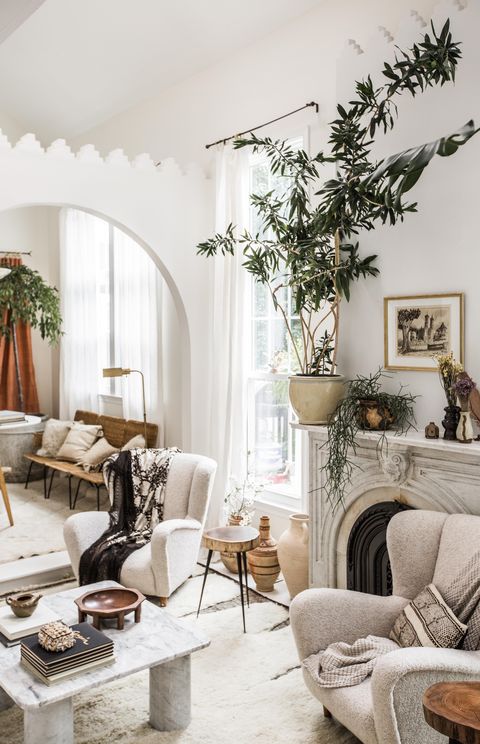 fireplace, white rug, white couch, plants