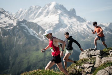 a group of people running on a mountain