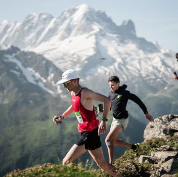 a group of people running on a mountain