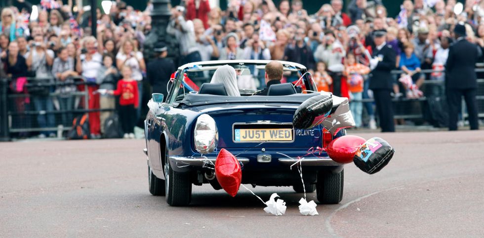 london, united kingdom   april 29 embargoed for publication in uk newspapers until 24 hours after create date and time prince william, duke of cambridge and catherine, duchess of cambridge leave buckingham palace on route to clarence house, driving prince charles, prince of waless 1969 aston martin db6 volante decorated with l plates, bunting, ribbons, balloons and a just wed number plate, following their wedding reception on april 29, 2020 in london, england the marriage of prince william, the second in line to the british throne to catherine middleton was led by the archbishop of canterbury and was attended by 1900 guests, including foreign royal family members and heads of state thousands of well wishers from around the world have also flocked to london to witness the spectacle and pageantry of the royal wedding photo by max mumbyindigogetty images
