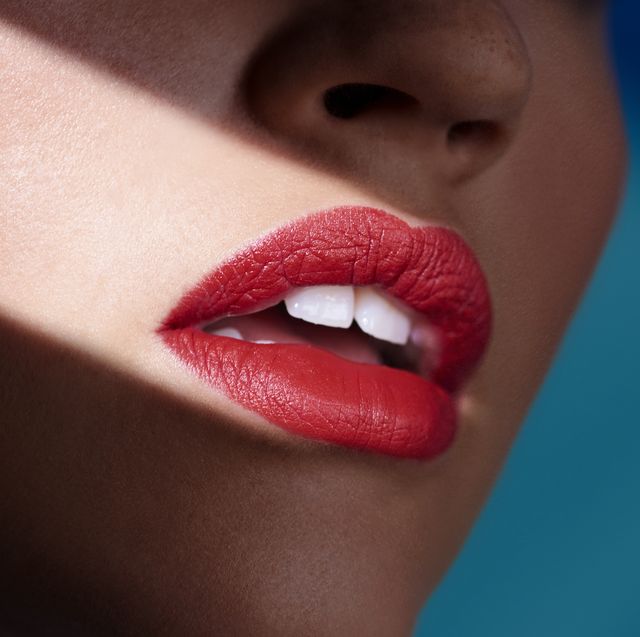 a womans mouth wearing red lipstick