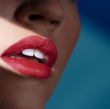 a womans mouth wearing red lipstick