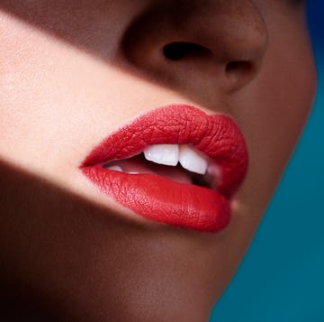 a womans mouth wearing red lipstick