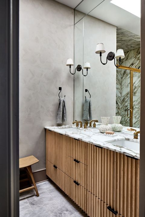 bathroom with sconces on the mirror