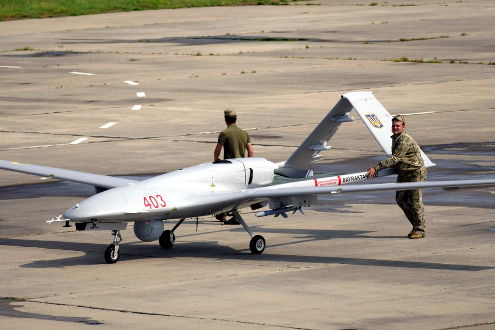 bayraktar tb2 drone on a concrete pad with two ukrainian military members