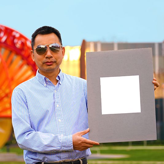 xiulin ruan, a purdue university professor of mechanical engineering, holds up his lab’s sample of the whitest paint on record purdue universityjared pike