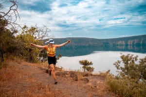 a person running along a scenic trail near a body of water