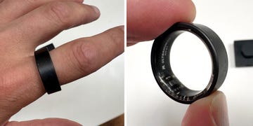 a person wearing and holding a black smart ring