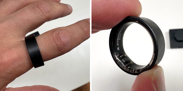 a person wearing and holding a black smart ring