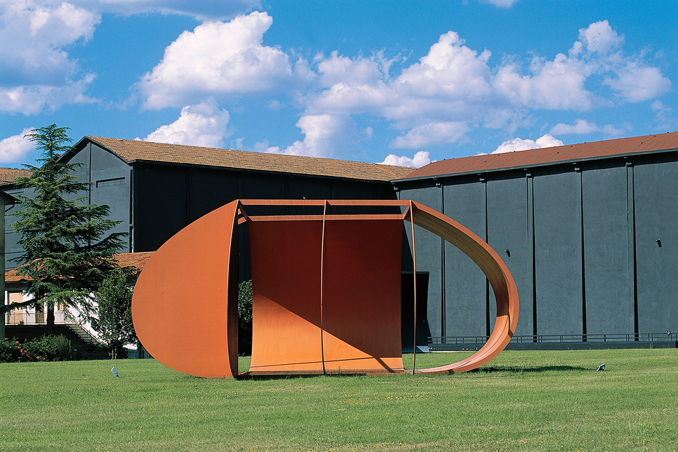 a building with a large orange and black structure in front of it