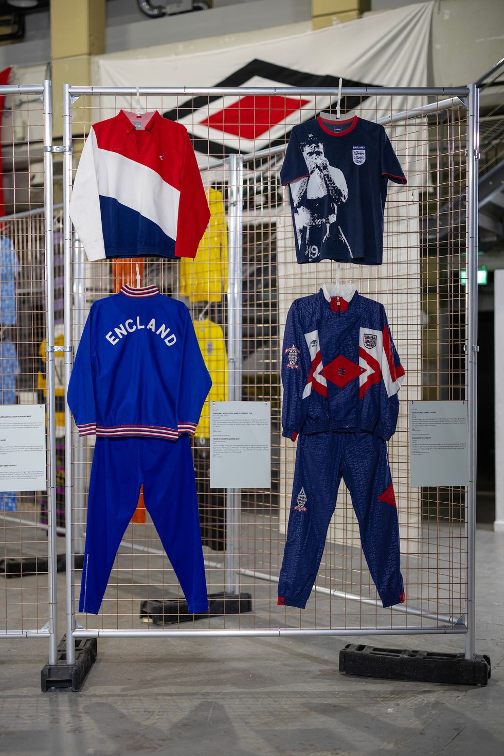 a couple of blue and red sports uniforms on a rack