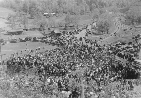 original caption approximately 6,000 to 7,000 people, most of them miners, are shown here massed together near harlan, kansas, as they listened to speakers of the united mine workers of america, after troops and been called out to supervise the reopening of coal mines, despite the "peace treaty" signed by representatives of operators and miners in new york at the meeting, speakers urged the miners to welcome the troops as cordially as those who requested their presence, for most of the national guardsmen are themselves sons of miners protected by 700 national guardsmen, miners reported for work on may 15, 1939 at the harlan pits