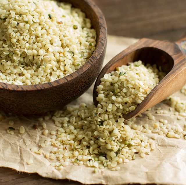 Uncooked Hemp seeds in a bowl with a spoon