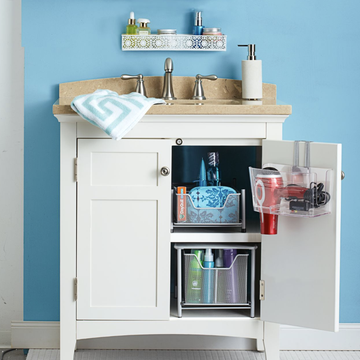 under the sink storage ideas, open bathroom cabinet with hair tools inside